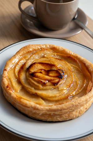 French fresh baked sweet puff pastry with fresh apple fruits in syrup in confectionery shop close upの写真素材