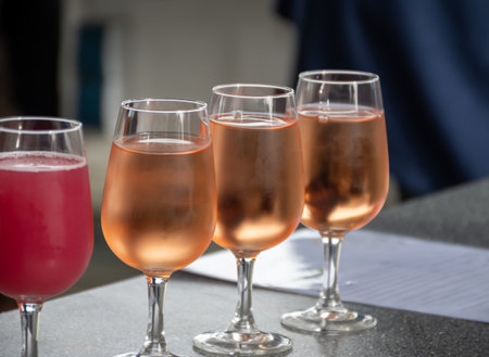 Tasting of white , rose, young dry wine made on Moselle river valley in Germany or Luxembourg, view on terraced vineyards , glasses of wineの写真素材