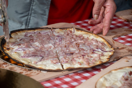 Traditional food of Alsace, flammekuche wood oven baked tarte with onion, bacon and sour cream, Franceの写真素材