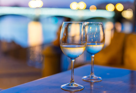 Two glasses of cold dry white wine served outdoor in tavern at night in historical Triana district, Seville, Spain, close upの写真素材