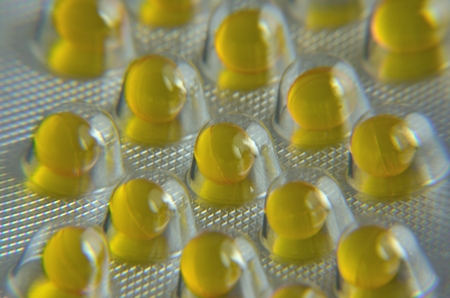 Several yellow tablets sealed in the packaging