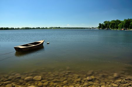 The boat moored at the lake shoreの写真素材
