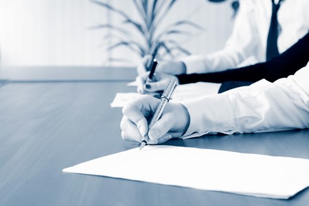 person's hand signing an important documentの写真素材