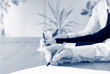 person's hand signing an important documentの写真素材
