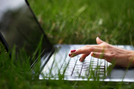 hands of a young girl working on laptopの写真素材