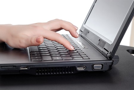 Female hands working on laptopの写真素材