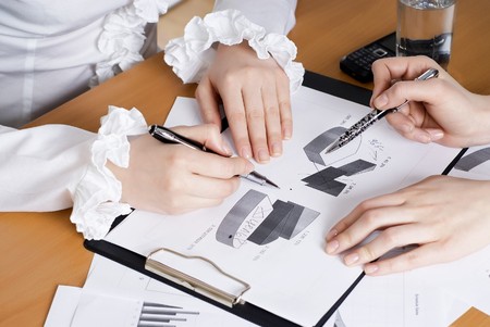 Hands of business women are actively discussing the business project.の写真素材