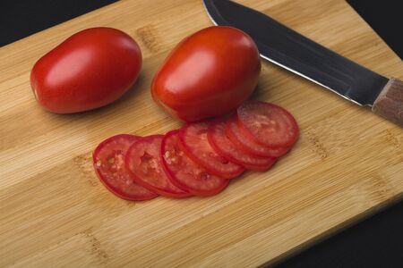 Red ripe tomato. Red ripe black tomato on the background. Close-up. Side view.A tomato.