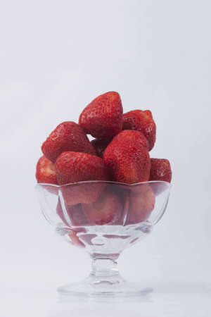 Strawberries on a white background. Ripe strawberries in a vase on an isolated white background.の写真素材