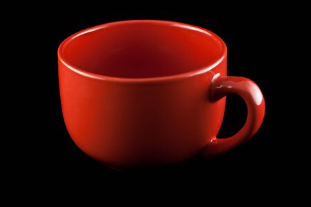 Red porcelain cup on a black background.の写真素材