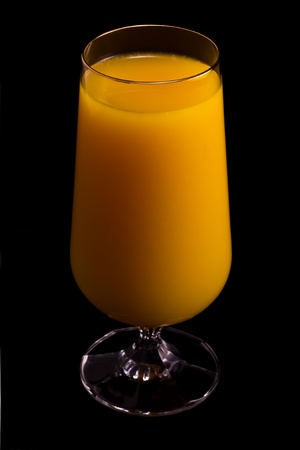 Glass of orange juice isolated on black.の写真素材