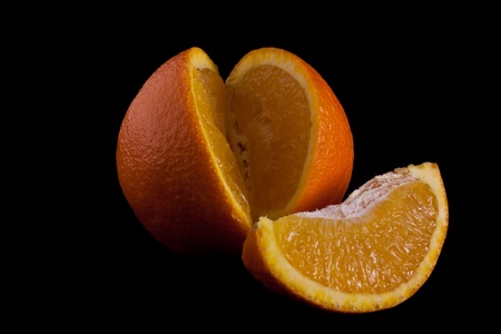 cut orange isolated on black background.の写真素材