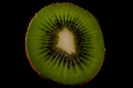 Sliced kiwi fruit isolated on a black background.の写真素材