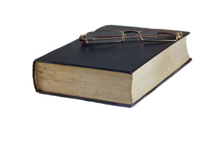 Glasses on a book isolated on white.の写真素材