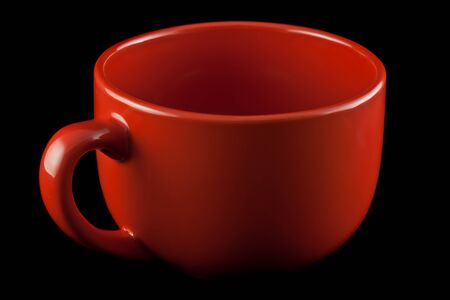 Red porcelain cup on a black background.の写真素材