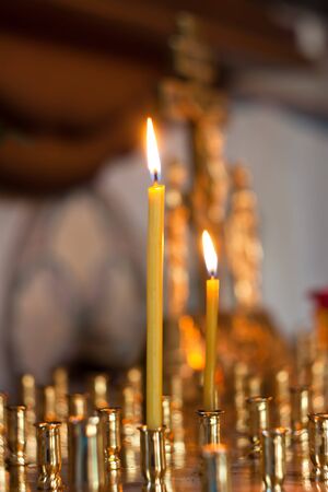 Burning wax candle in the church.の写真素材