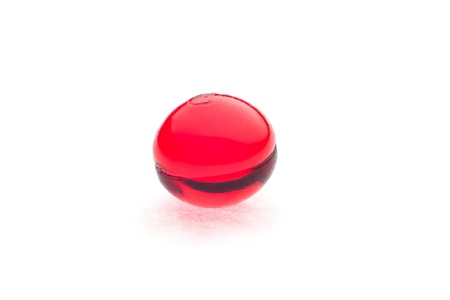 One red pills isolated on white background.の写真素材