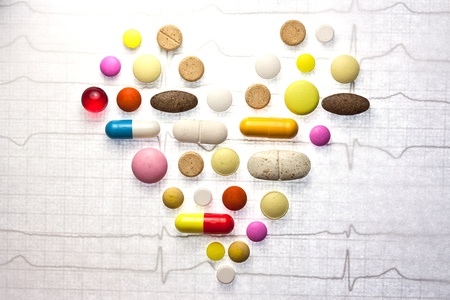 Different pills posted on ECG in the form of the heart の写真素材