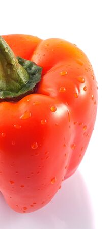 Juicy orange pepper with drops of water on a white background の写真素材