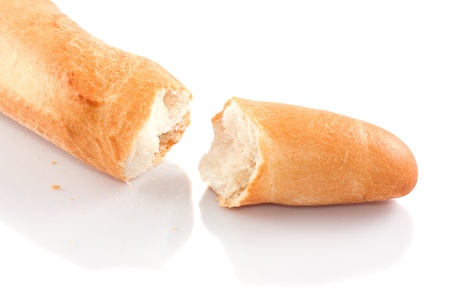 Broken loaf of bread gold on a white background の写真素材