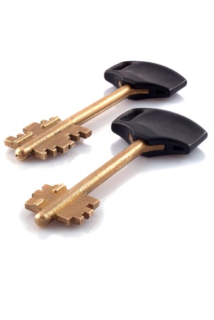 Two golden metal key, isolated on a white background の写真素材