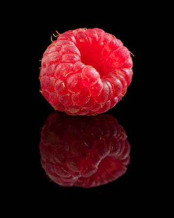 One ripe raspberry on black background の写真素材