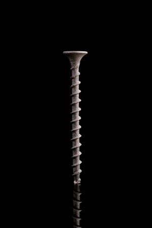 One black screw on a black background の写真素材