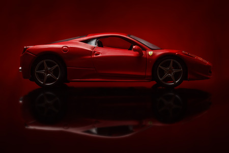 KRIVOY ROG, UKRAINE - AUG 22- Toy ferrari 458 Italia on red background, Friday 22 August 2014のeditorial素材