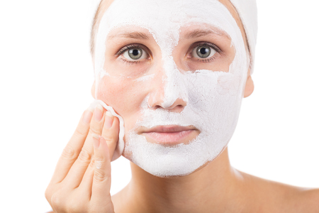 A young girl makes a face mask.の写真素材