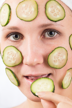 A young girl makes a face mask.の写真素材