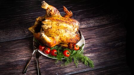 Baked in the oven, with a golden crust a whole chicken on a plate.の写真素材
