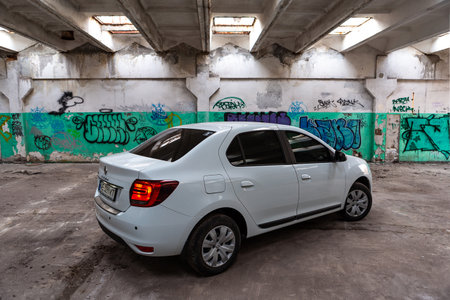 Krivoy Rog, Ukraine - April 11, 2021: Photo of white Ranault Logan against the background of street art.のeditorial素材