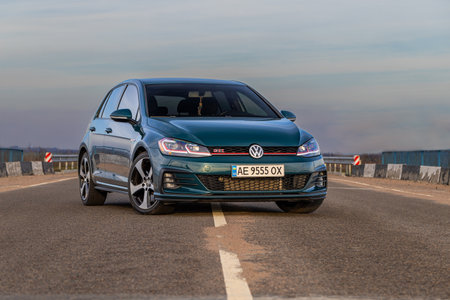 Krivoy Rog, Ukraine â March 24, 2024: Photo of green car Volkswagen Golf GTI on the street.のeditorial素材