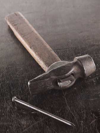 wooden metallic hammer and metallic tack on the tableの写真素材