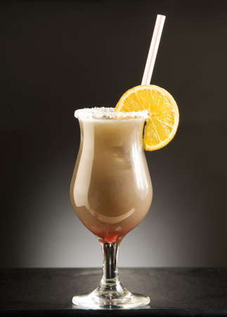 colorful cocktail with orange sugar and tube on the tableの写真素材