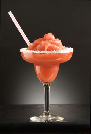 red alcohol cocktail with sugar and tubeの写真素材