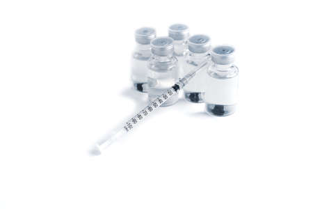 Empty bottle of vaccine with syringe and mask for hygiene injection.の写真素材