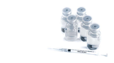 Empty bottle of vaccine with syringe and mask for hygiene injection.の写真素材