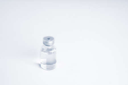 Empty bottle of vaccine with syringe and mask for hygiene injection.