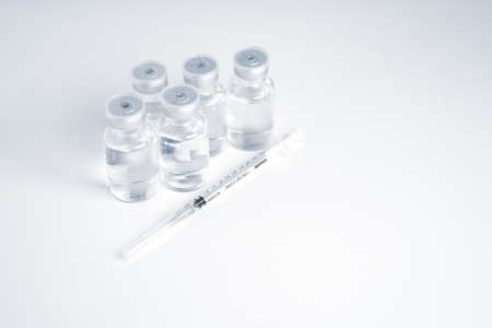 Empty bottle of vaccine with syringe for hygiene injection.