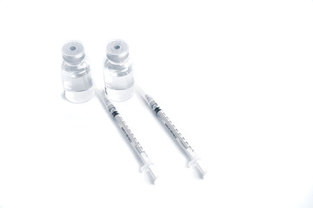 Empty bottle of vaccine with syringe and mask for hygiene injection.の写真素材