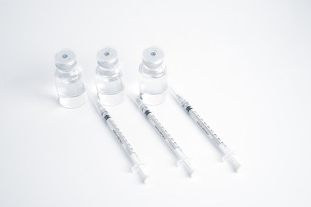 Empty bottle of vaccine with syringe and mask for hygiene injection.の写真素材