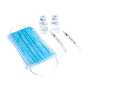 Empty bottle of vaccine with syringe and mask for hygiene injection.の写真素材