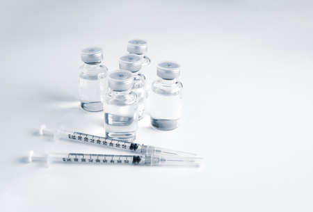 Empty bottle of vaccine with syringe and mask for hygiene injection.の写真素材