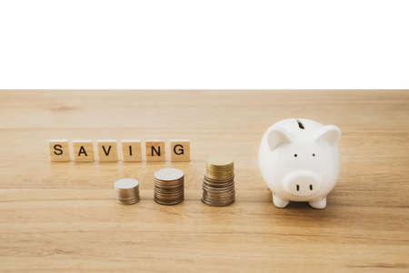 Saving concept of financial improvement progress by stack of coin or cash growing on wooden background. Rising of graph or tree on money show for treasure and wealth of growth economy.の写真素材