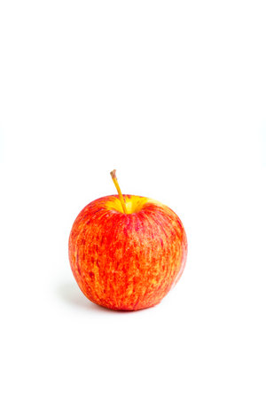 Hand hold red, yellow apple cutout on isolated white background. This juicy healthy fruit is very tasty and has natural vitamin with antioxidant nutrition. Eat as health and diet food.の写真素材
