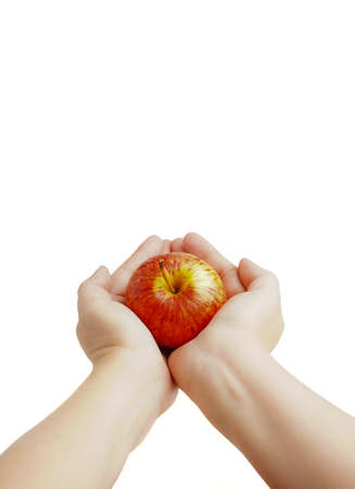 Hand hold red, yellow apple cutout on isolated white background. This juicy healthy fruit is very tasty and has natural vitamin with antioxidant nutrition. Eat as health and diet food.の写真素材