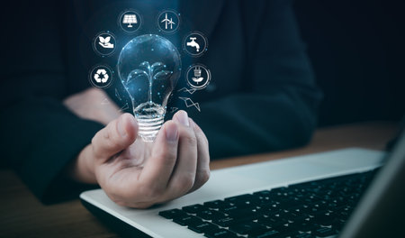 Power concept Ecology Elements energy sources. Hand hold light blub. Innovation and invention glow environment thinking sustainability, reusable, renewable power for bright future responsibility.の写真素材