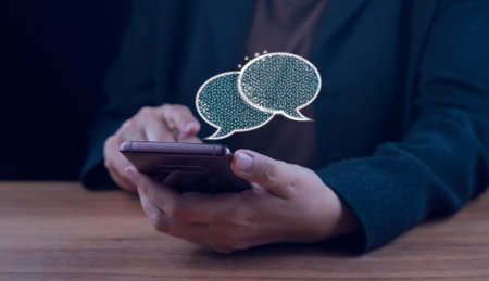 Digital chatbot, chat robot application, conversation assistant, AI Artificial Intelligence concept. Man using mobile smart phone, with digital chatbot on virtual screen. Hand typing  Live Chatting.の写真素材