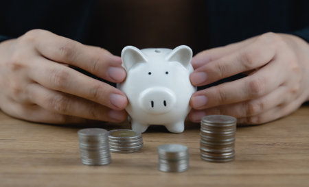 Money coin stack and piggy bank for saving money, wealth and financial concept. Crop close up photo. Investment for rich, retirement. Financial management for future or deposit money for family.の写真素材